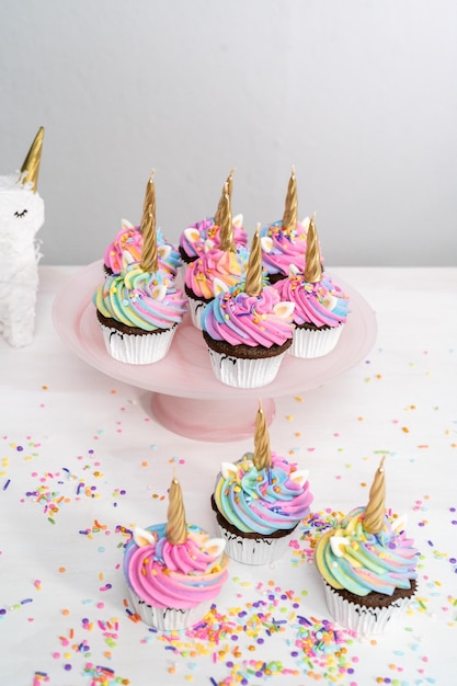 Unicorn cupcakes decorated with colorful buttercream icing and sprinkles.