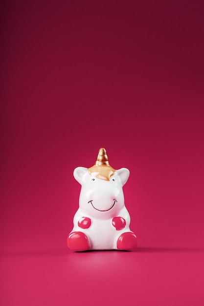 Unicorn figurine on a pink background