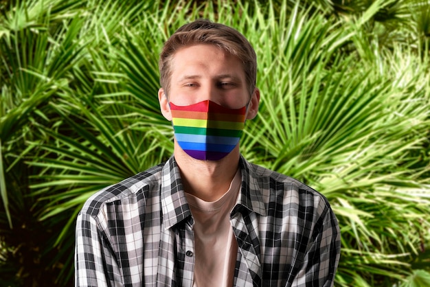 An unidentified person wearing protectove face mask with rainbow colors lgbt concept