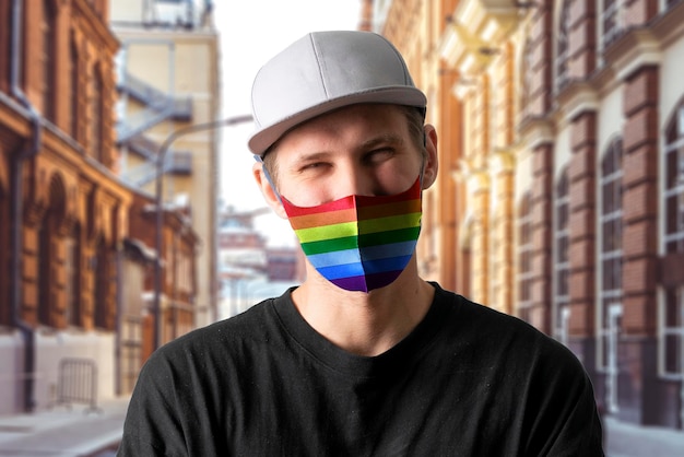 An unidentified person wearing protectove face mask with rainbow colors lgbt concept