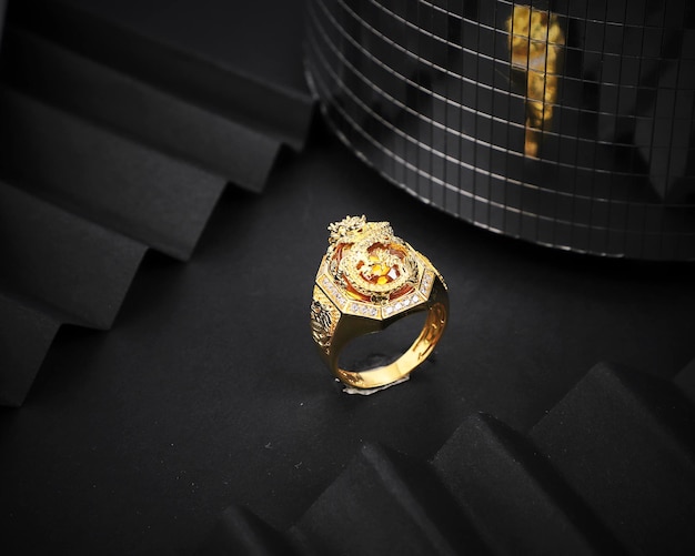 Unique gold men's ring on black background Precious jewelry