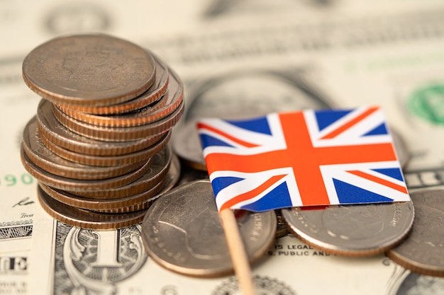 United Kingdom Flag on coins background , Business and finance concept.