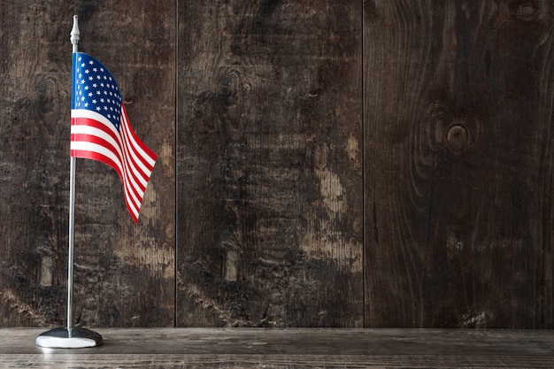 United States flag on a rustic wooden table 