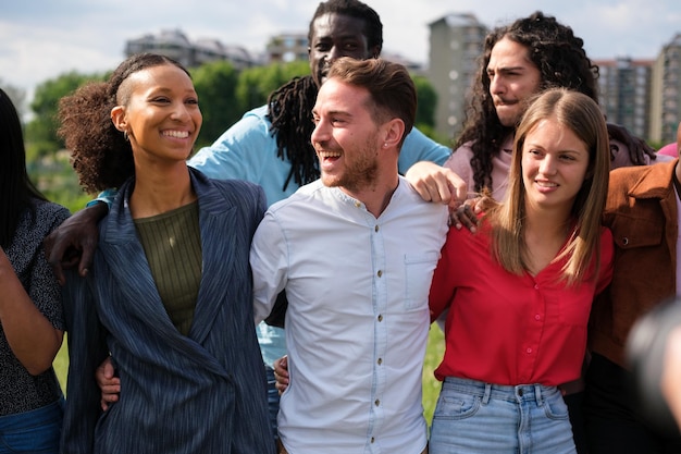 United young people from different cultures having a fun time outdoors