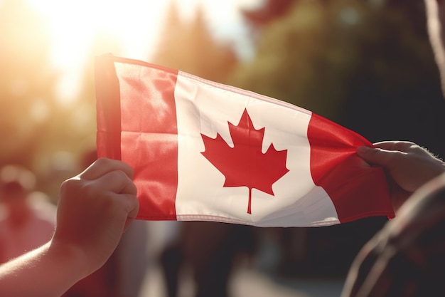 An unknown individual proudly waves the Canadian flag highlighted against the warm glow of the setting sun celebrating a national event