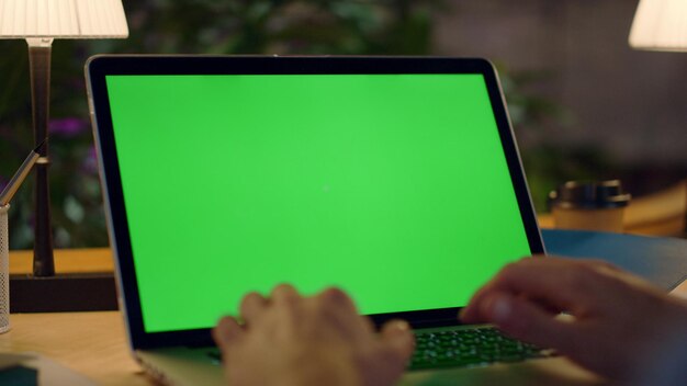 Unknown man hands working green screen computer Guy typing on laptop in office