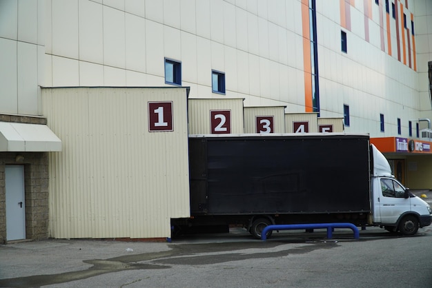 Unloading a truck near the gates of a warehouse or shopping cent