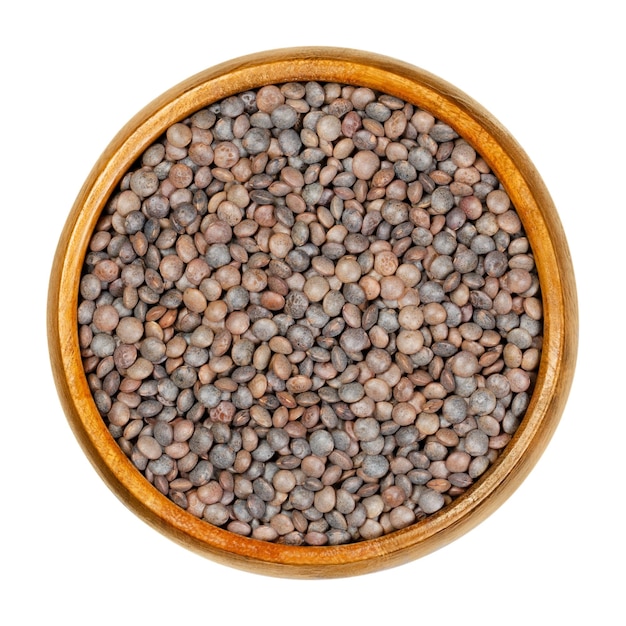 Unpeeled red lentils in wooden bowl