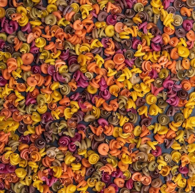 Unprepared fusilli pasta multicolored spiral of wheat flour