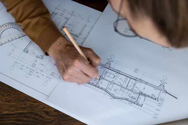 Unrecognizable architect designer sketching drawing design of house engineer working on architectural project in office