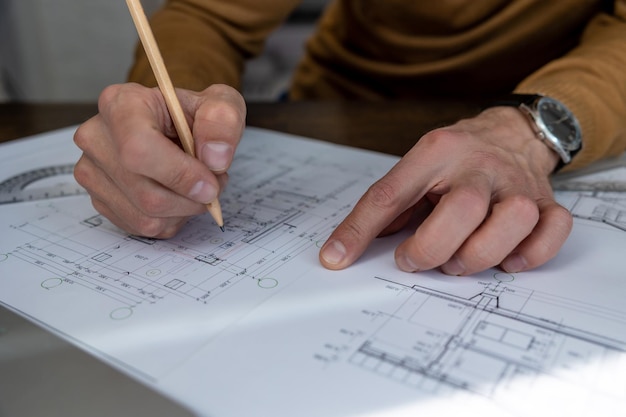 Unrecognizable architect designer sketching drawing design of house engineer working on architectural project in office