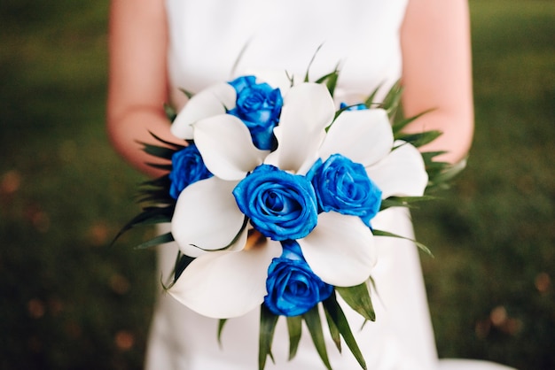 Unrecognizable bride holding her bouquet of flowers on her wedding day