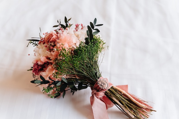 Unrecognizable bride holding her bouquet of flowers on her wedding day