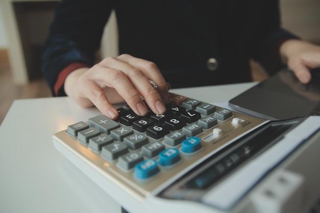 Unrecognizable businessman using calculator