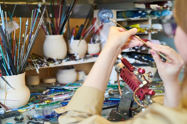 Unrecognizable Female Artist Making Glass Sphere