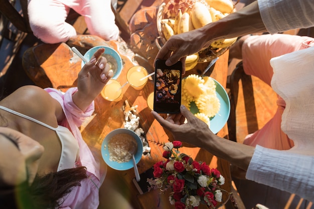 Unrecognizable Man Taking Photo Of Table Served 