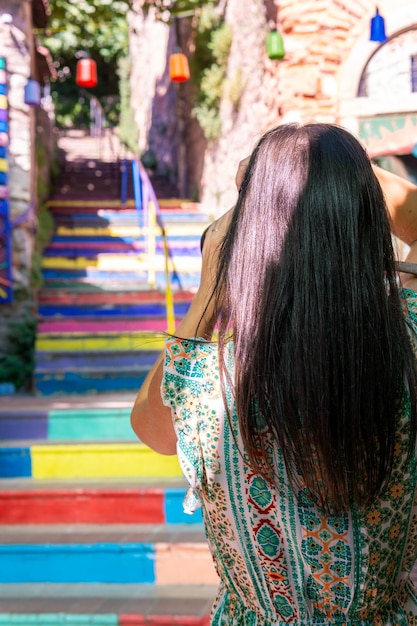 Unrecognizable photographer photographing colorful stairs in istanbul turkey