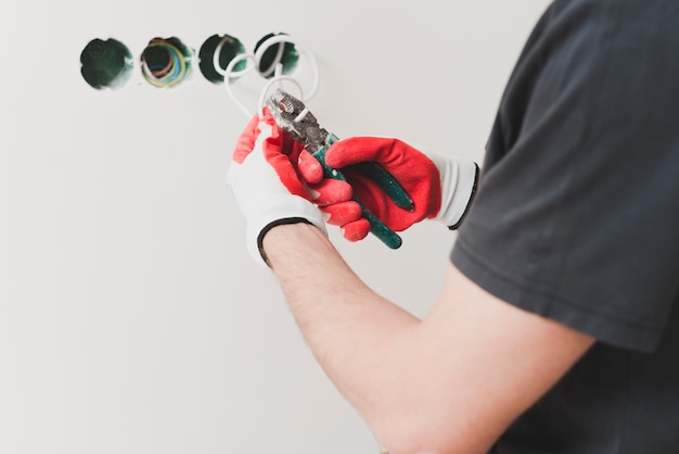 Unrecognizable repairman cutting wire