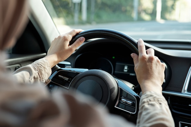 Unrecognizable woman driving car