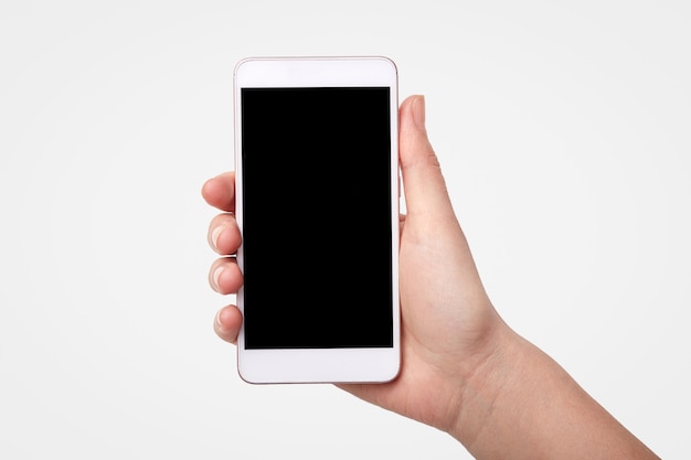 Unrecognizable woman holds smart phone with blank screen