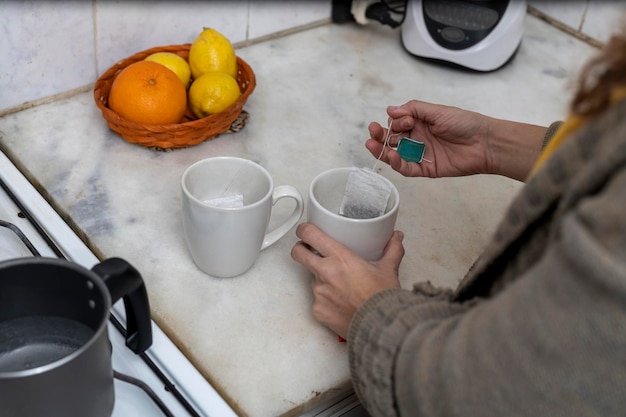 Unrecognizable woman making tea