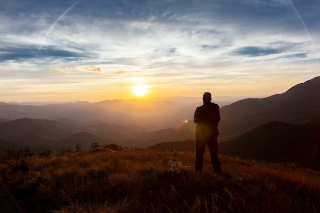 Unrecognized people enjoying the mountain landscape view from a mountain