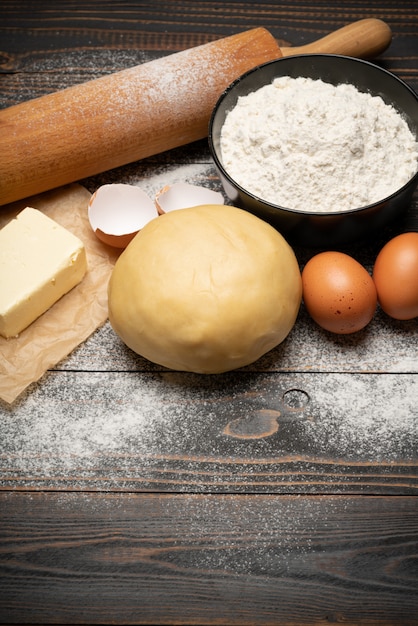 Unrolled and unbaked Shortcrust pastry dough recipe on wooden background