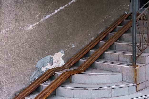 Unsafe metal rusty rails are installed on the stairs for people with disabilities Down Step Concrete Rail Urban Railing Assistant Chair Driveway Facility Falling Free Handicap Help