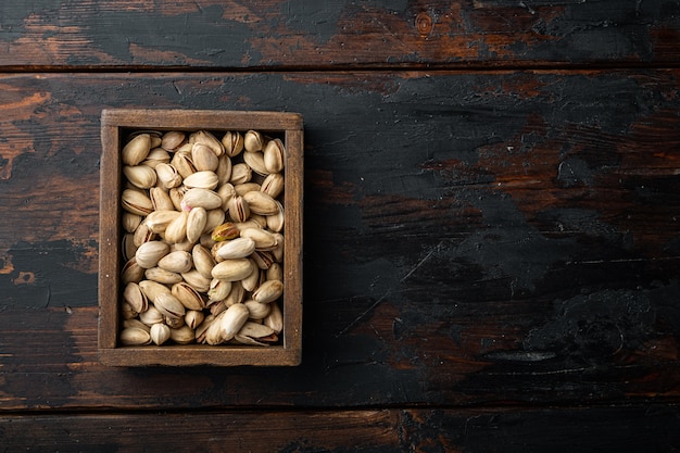 Unsalted pistachios on old wooden table