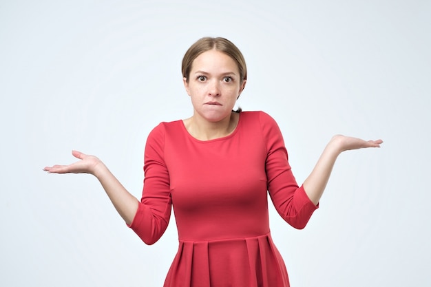 Unsure woman with shrug and hands out gesturing uncertainty