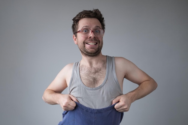 Untidy dressed man in big glasses smiling going crazy of self isolation at home