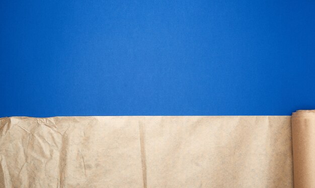 Untwisted roll of brown parchment paper on a blue background