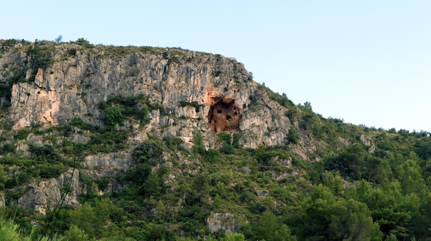 Unusual caves in the rock above. Four caves. Mountains of Spain, Alicante