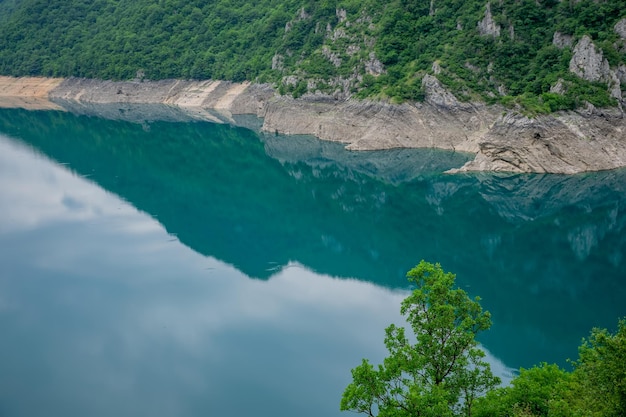 An unusual mountain lake with turquoise water is located in a canyon among the high mountains