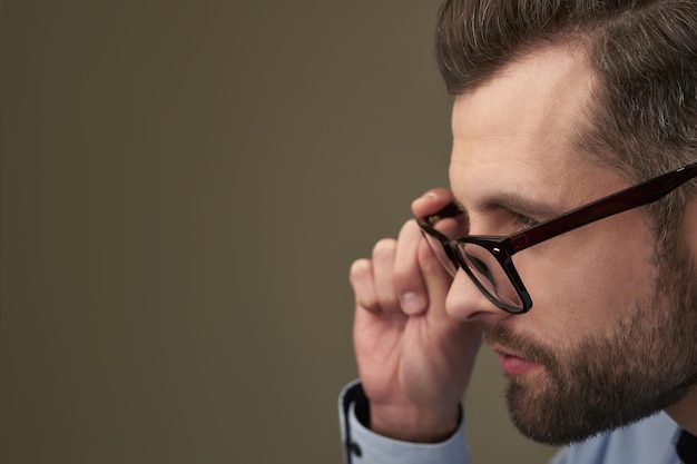 Unwinking stare of the serious bespectacled man