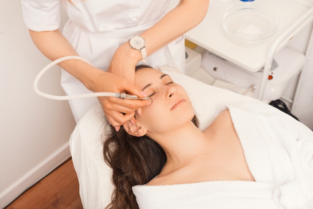 Up side view on a young woman in a beauty center.