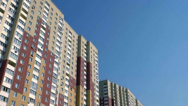 Up view of a new colored high rise building blue sky background