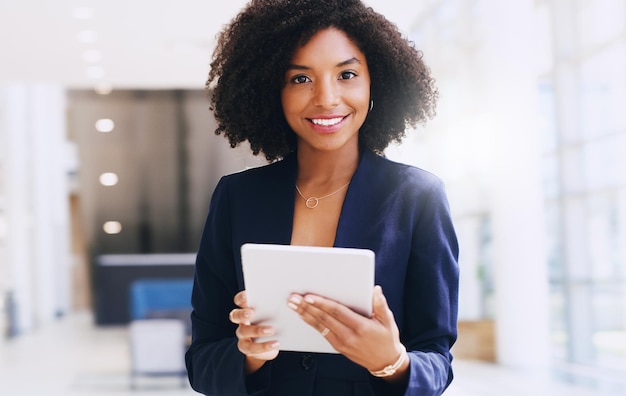 Updating my work schedule cropped portrait of an attractive young businesswoman standing alone and u