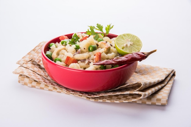 Upma or Uppittu is a popular breakfast dish in South India and Maharashtra. Semolina or Rava or coarse rice flour is main ingredients. Served in a bowl over colourful or wooden background