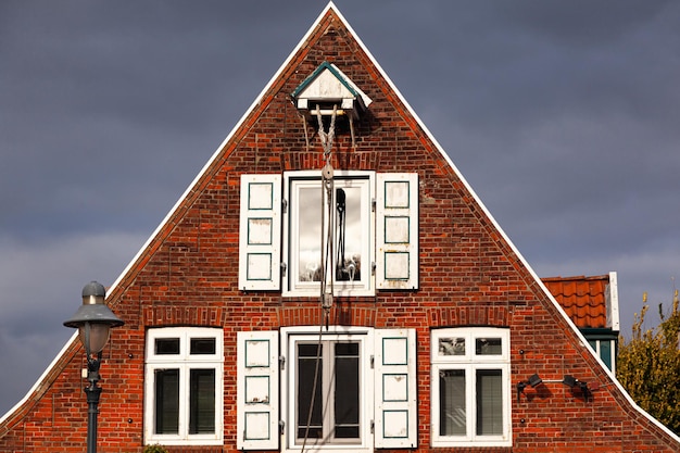 The upper part of a brick old German private house with casement windows