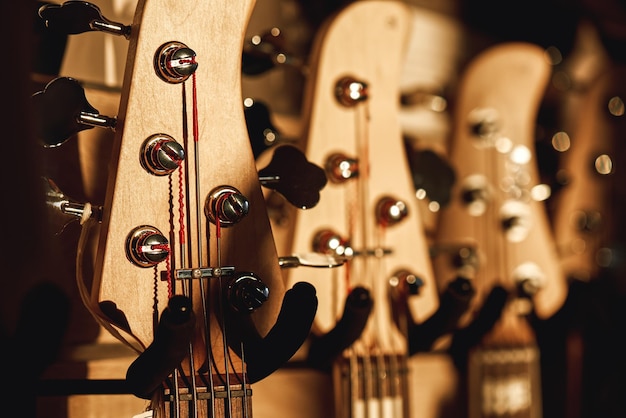 Uppermost part of the guitar close view of several acoustic guitar headstocks with tuning keys