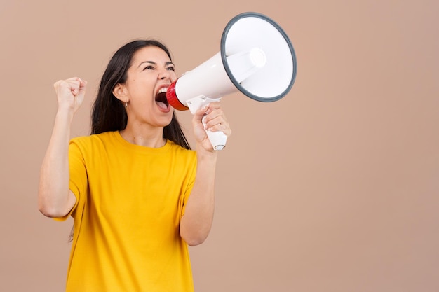 Upset caucasian woman yelling using a loudspeaker