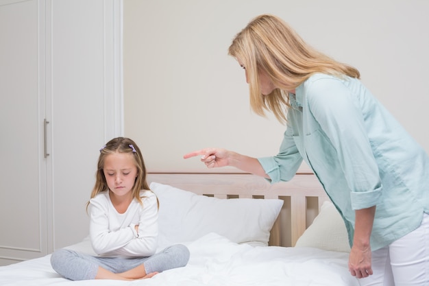 Upset mother scolding her daughter 