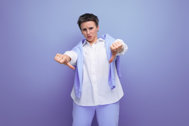 Upset pensive young darkhaired woman with a short haircut in a white shirt