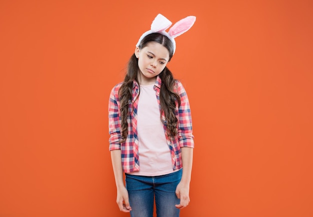 Upset teen girl in funny bunny ears for easter holiday happy easter