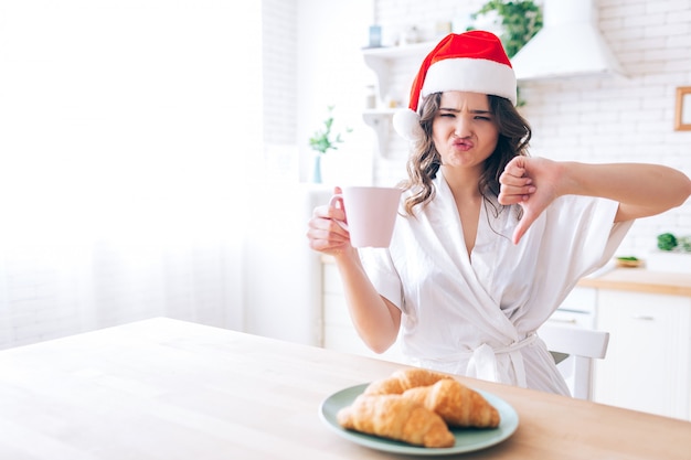 Upset unsatisfied young woman with red hat