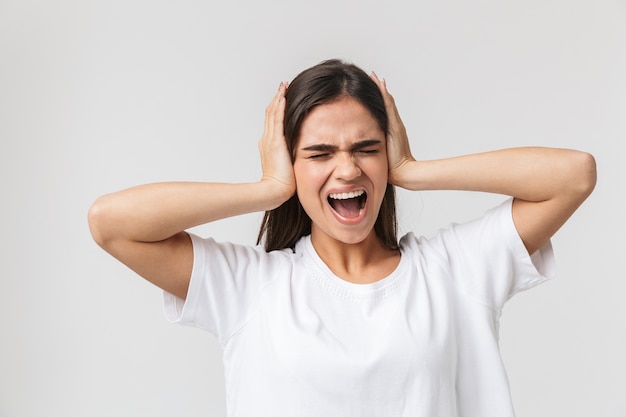 Upset young woman suffering from a headache isolated on white