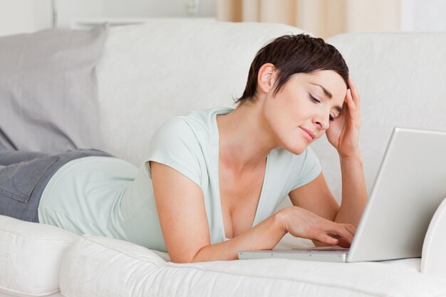 Upset young woman using a laptop