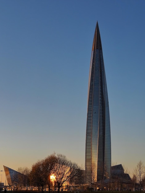 Urban landscape Skyscraper Lakhta Center in golden color at sunset