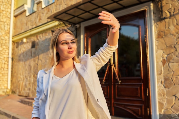 Urban outdoor portrait of young woman looking at setting sun